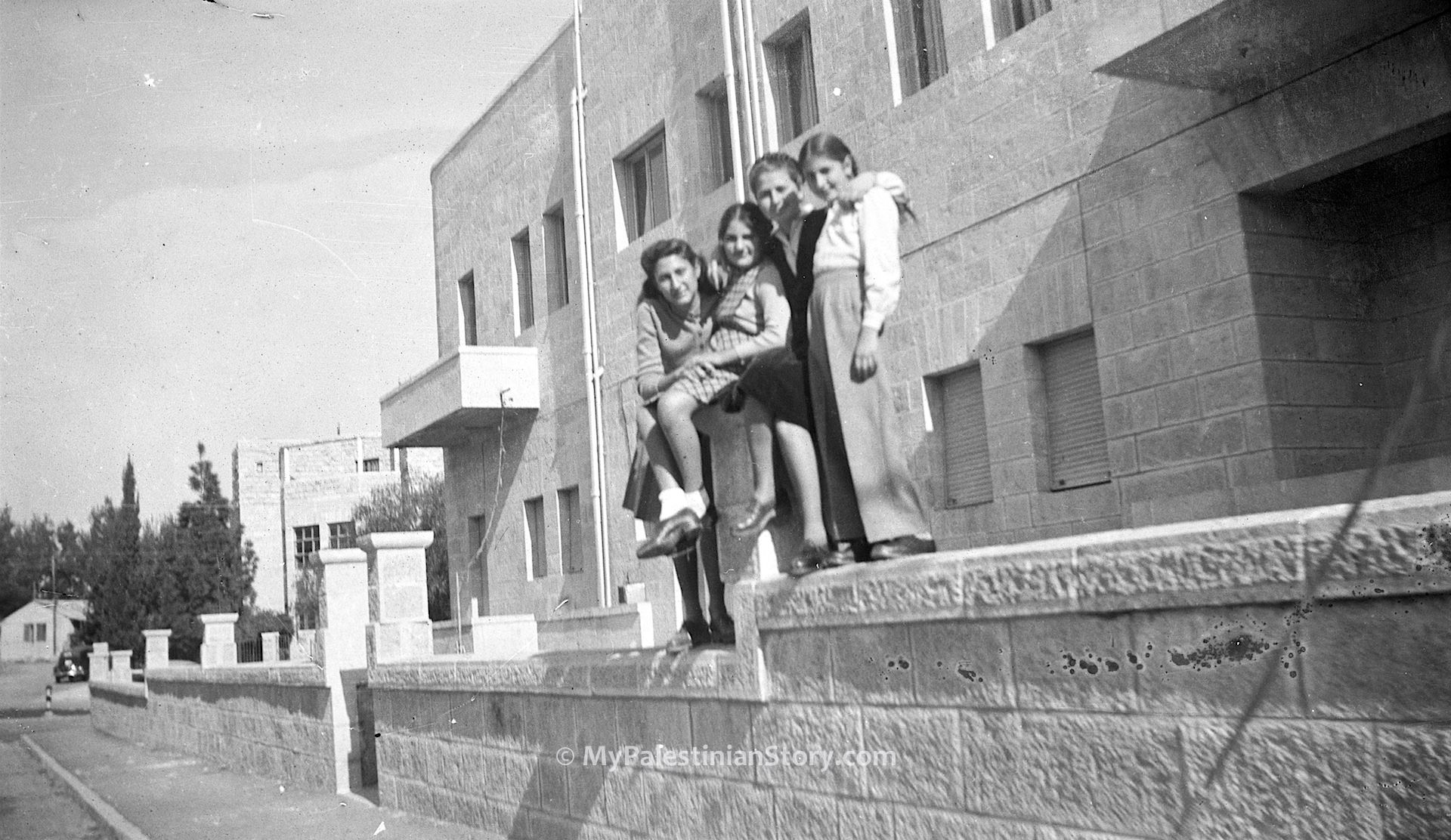 Feely, Jenny, Anna, Mary on the fencing wall of what was to be the Jordanian Embassy